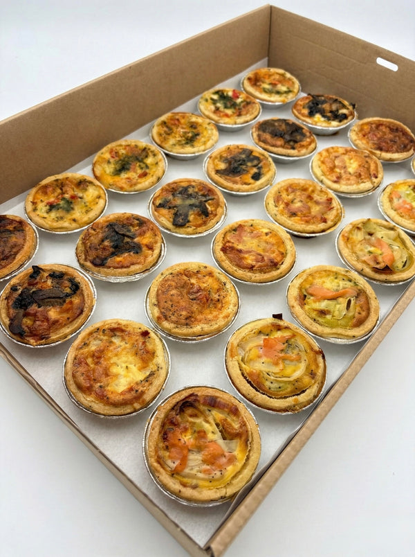 Hand-crafted mini savoury quiches with seasonal French ingredients for office lunch and event platters.