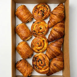 Selection of French pastries and viennoiseries for corporate breakfast meetings and event catering. Pain au chocolat, snails and croissant.