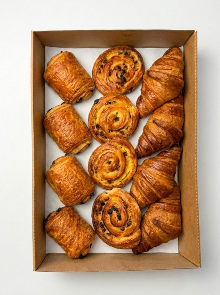 Selection of French pastries and viennoiseries for corporate breakfast meetings and event catering. Pain au chocolat, snails and croissant.